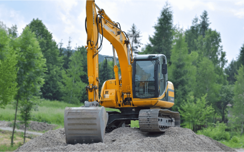 Excavation contractor using machinery to prepare a residential property site in Ontario