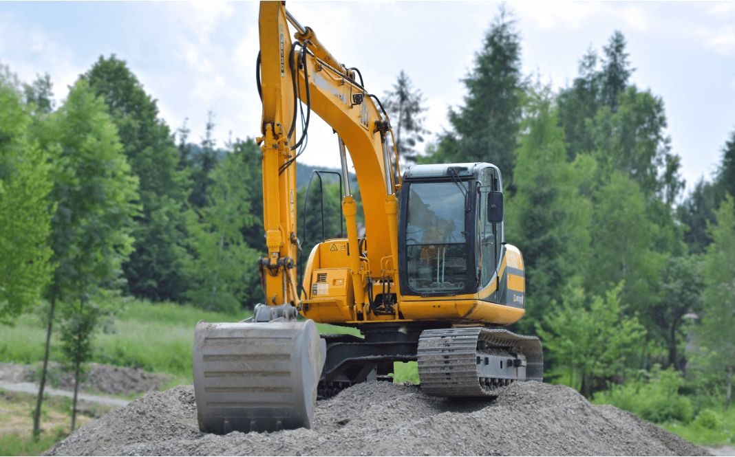 Excavation contractor using machinery to prepare a residential property site in Ontario